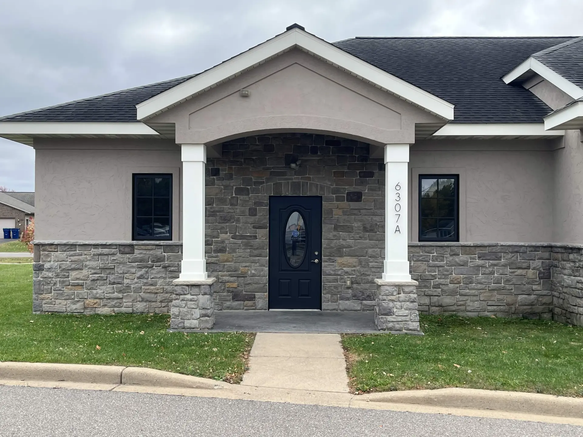 Weston Psychiatric side entrance after the repaint, black door between white columns.